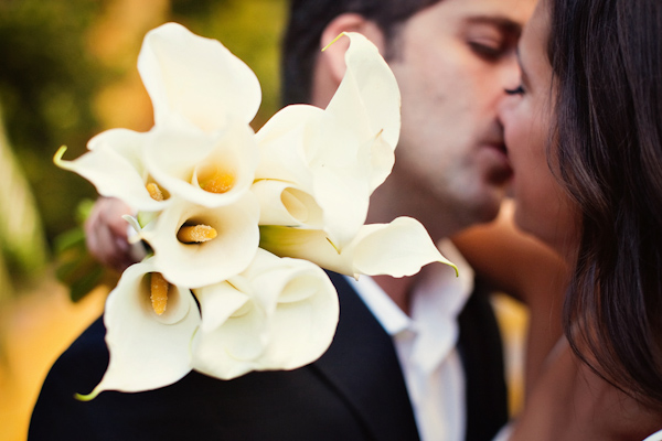 photo by Denver based wedding photographer Jared Wilson - the happy couple kissing - bride holding calla lily bouquet